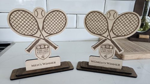 	Personalized wood pickleball paddle trophies on wood bases